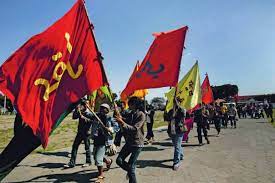 People marching with large red flags